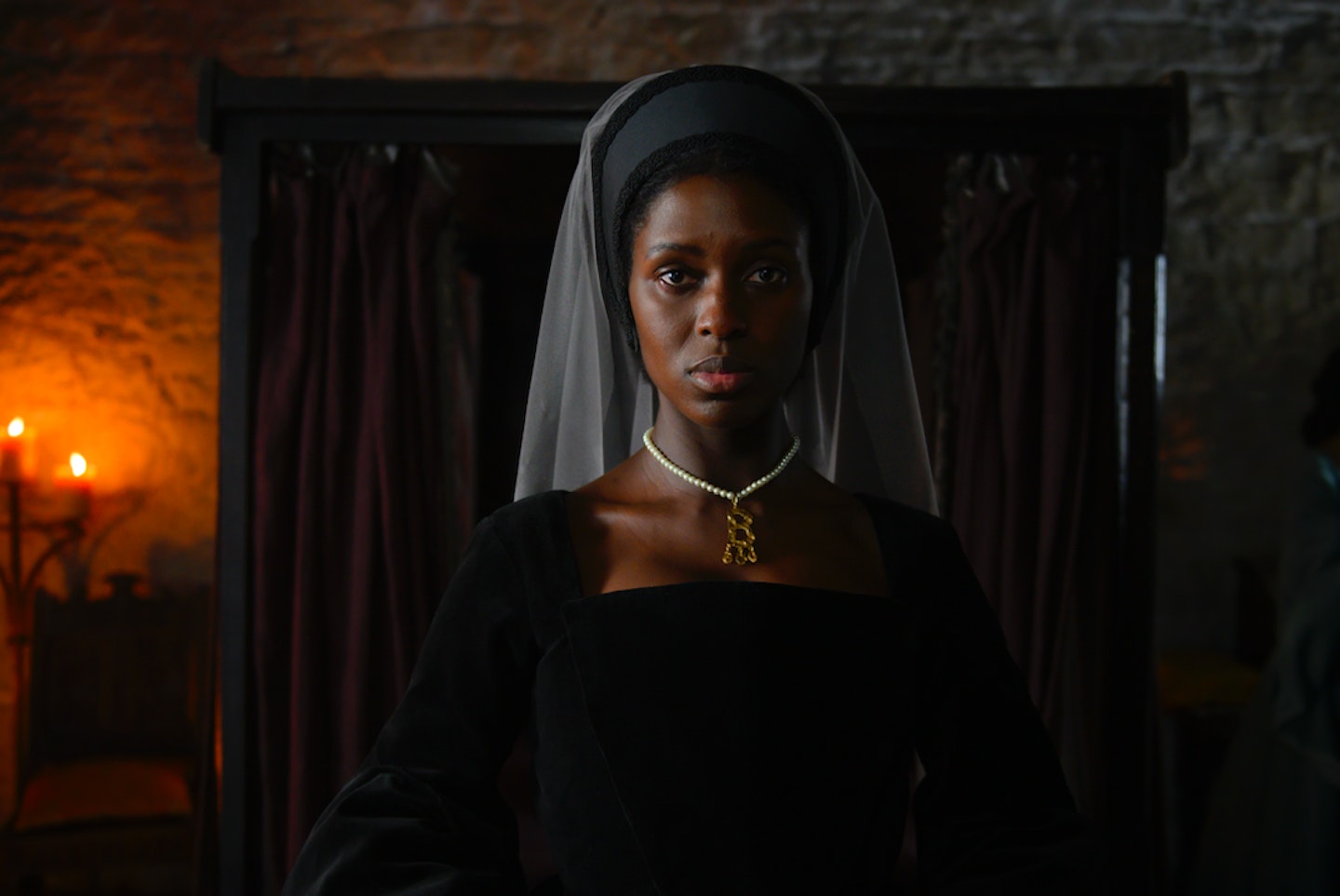 Jodie Turner-Smith in black gown as Anne Boleyn