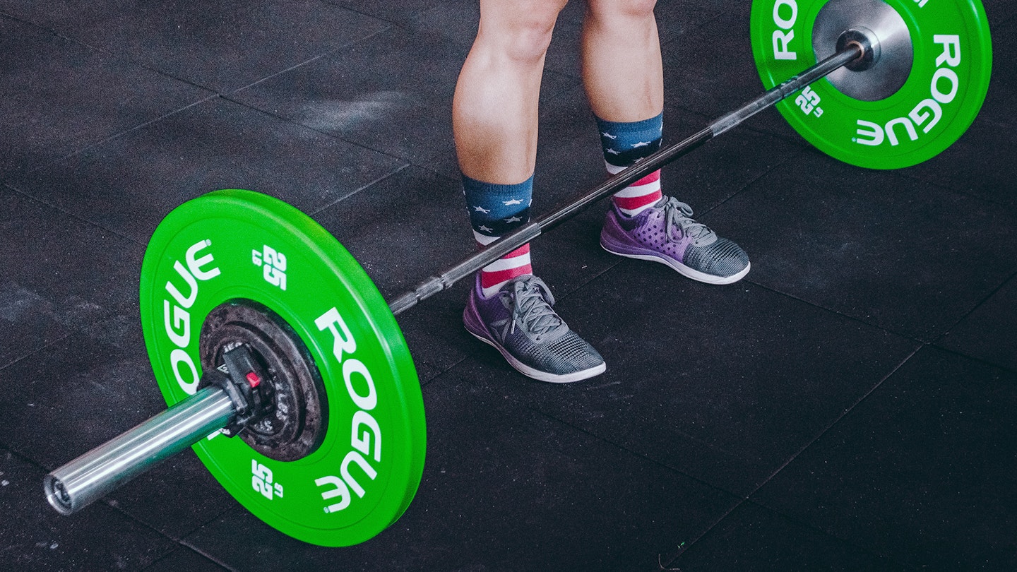 Close up shot of a woman's weightlifting shoes in action 