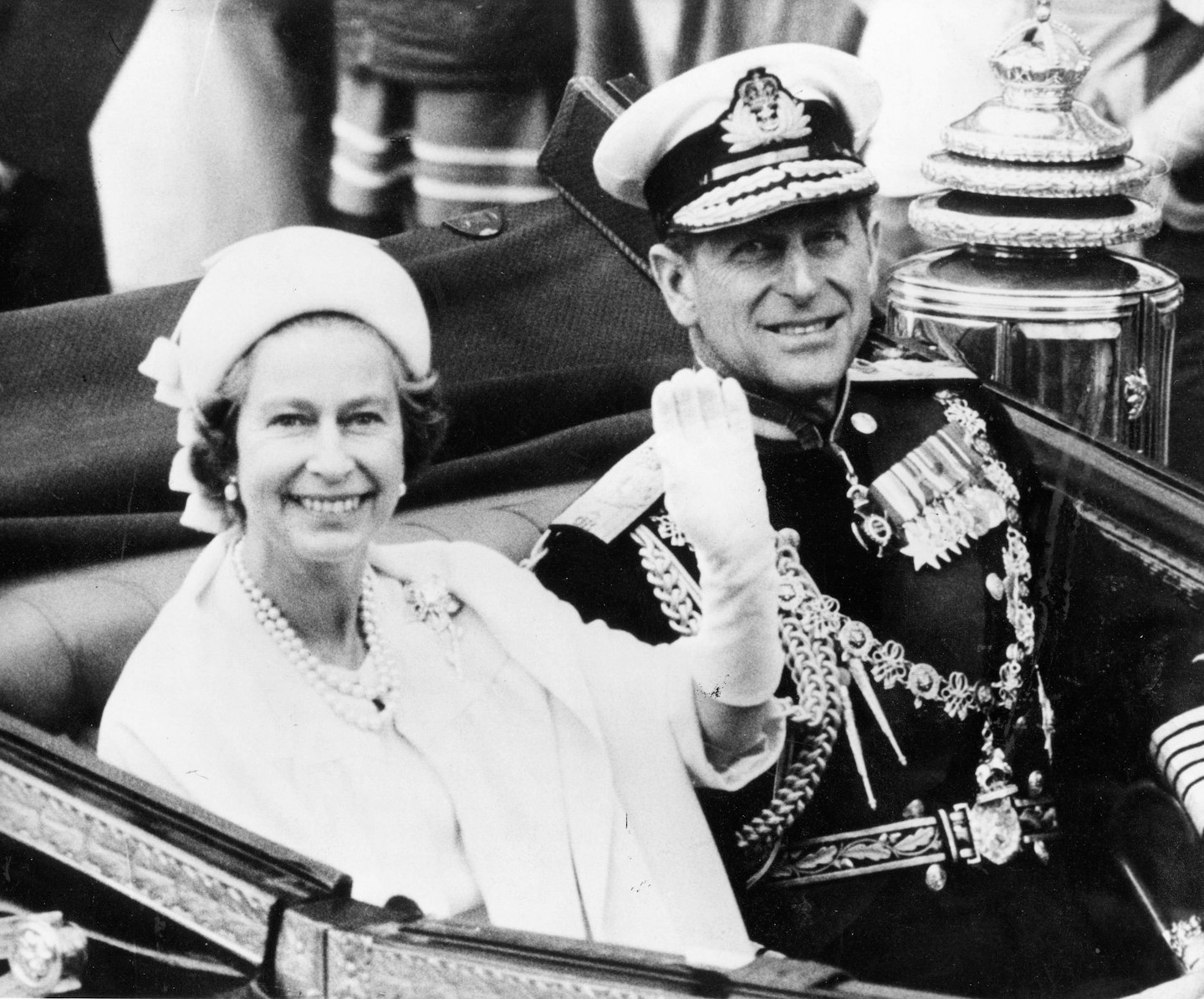 Queen Elizabeth II with her husband Prince Philip waving