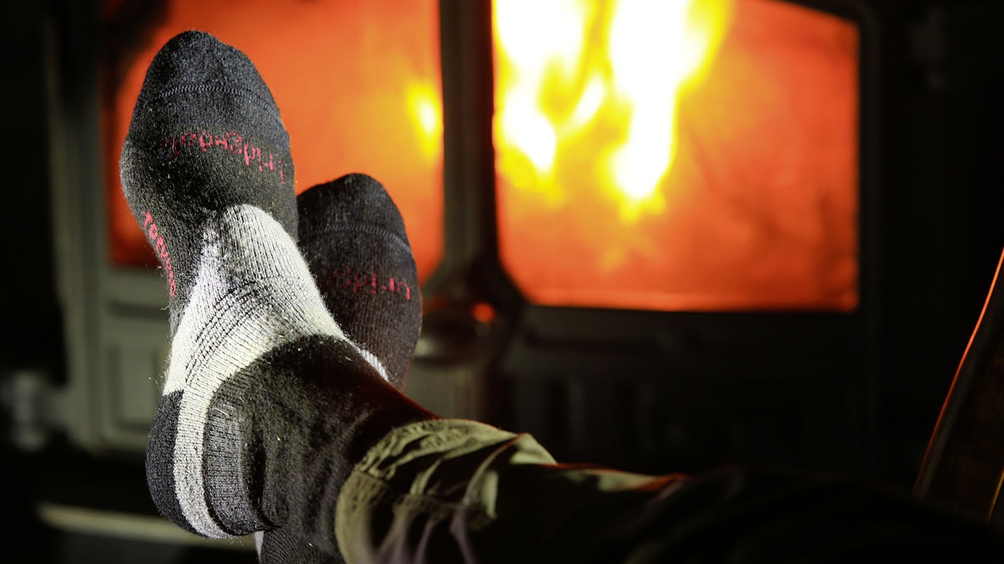 Walking socks in front of a fireplace