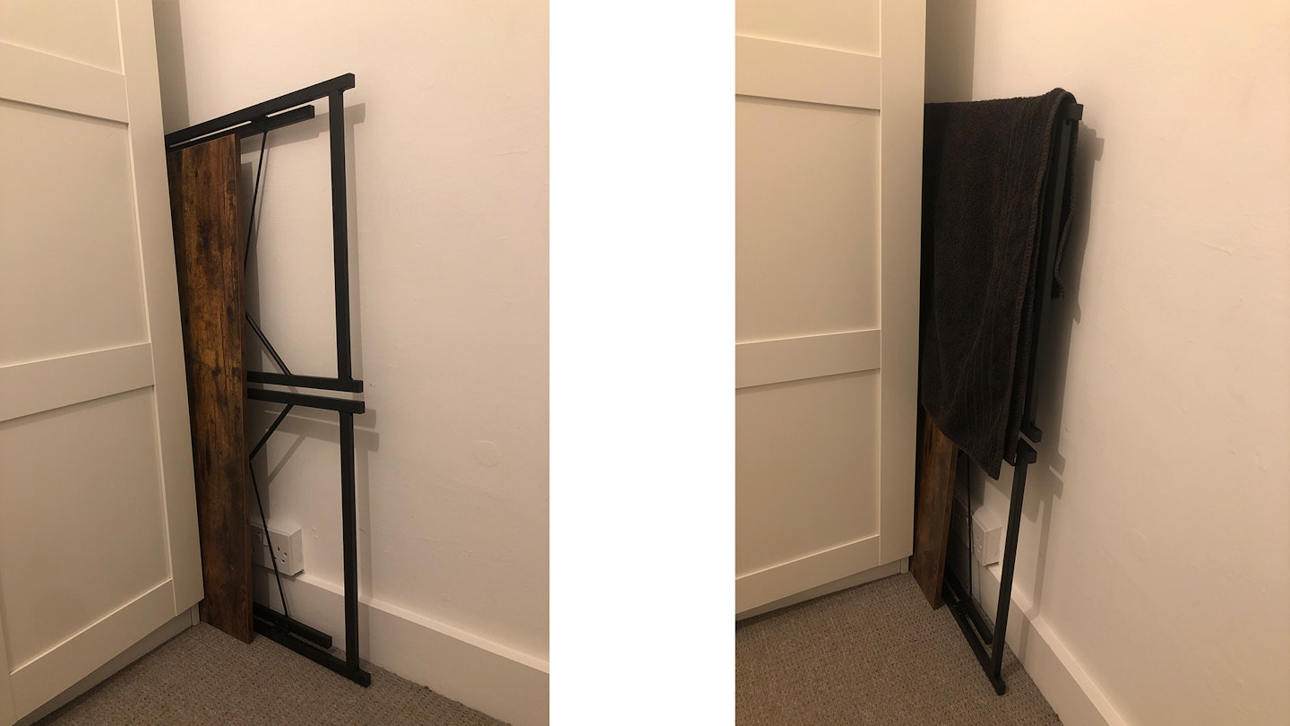 Folding desk neatly put away and used as a towel rack