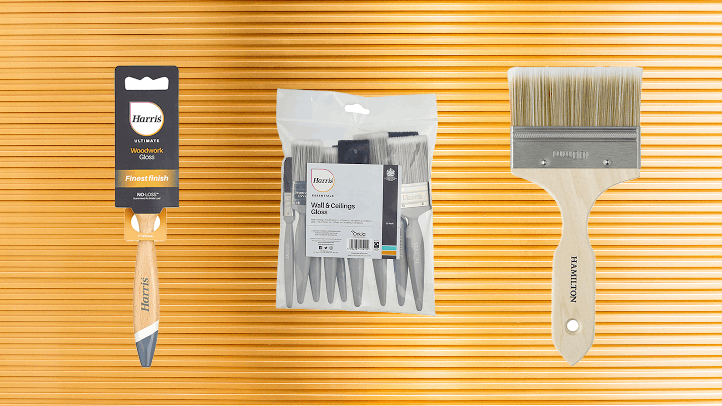 Three of the best paint brushes for gloss against a shiny textured painted surface