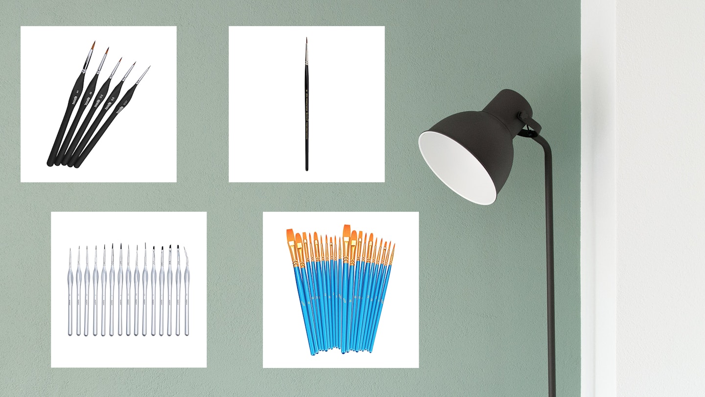 Four of the best miniature paint brushes against a green painted living room wall and a light
