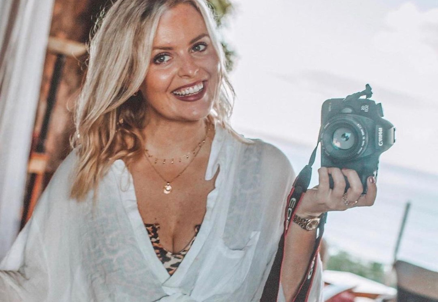 Picture of a r influencer smiling with a camera doing a