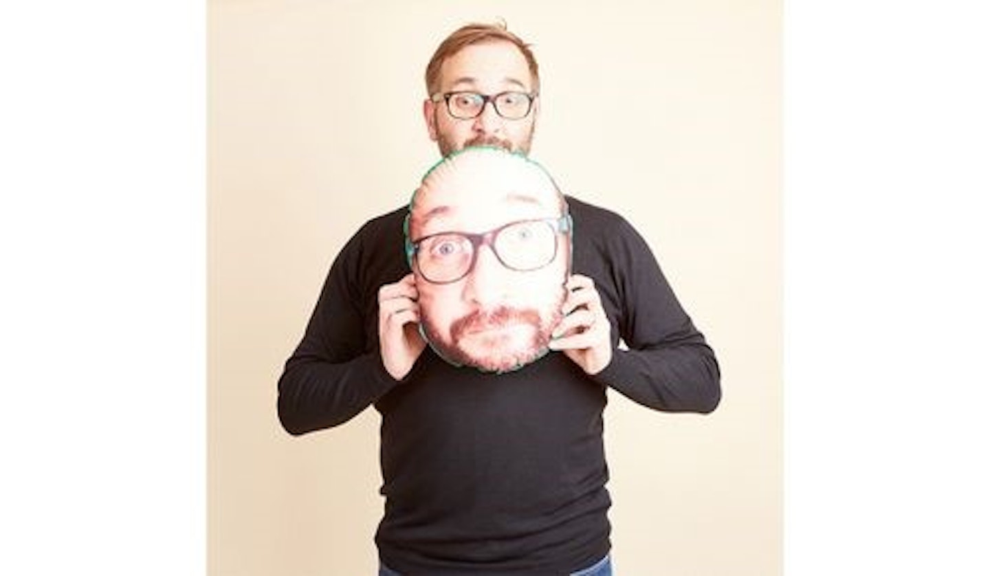 Man holding face cushion