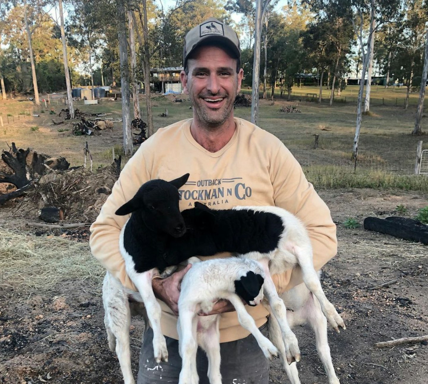 Mick Gould poses on Australian farm holding goats