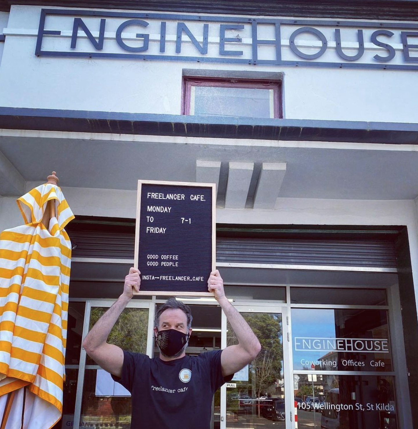 Mark Scrivens poses in from of his cafe in Melbourne for instagram