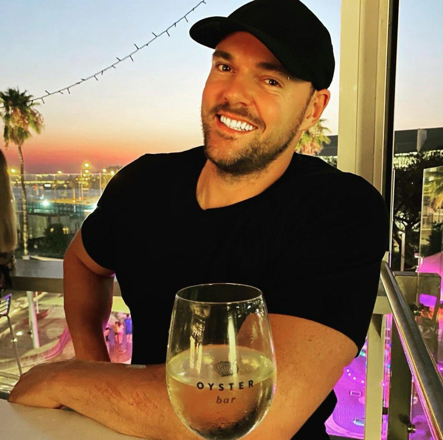 Bronson Norrish poses with wine for instagram post