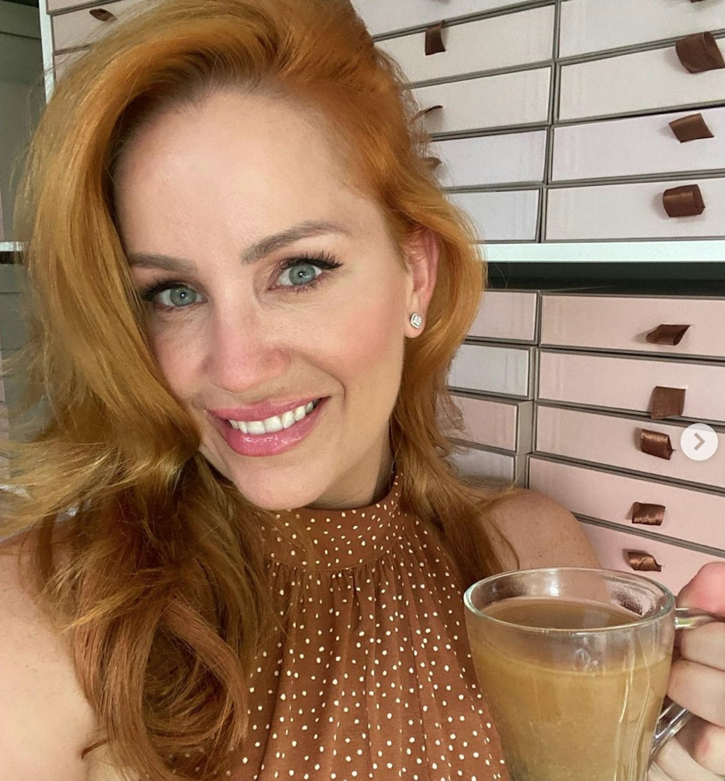 Jules Robinson poses for instagram post with coffee in hand