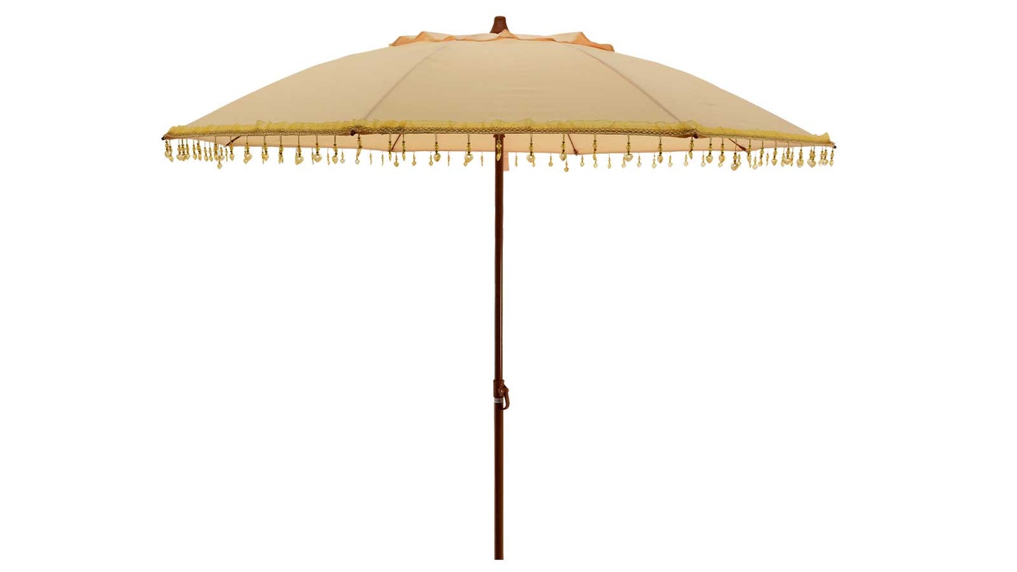 Yellow garden parasol with tassels