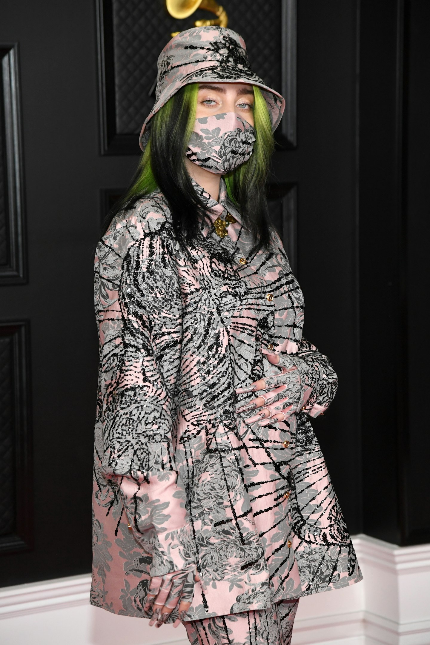 Billie Eilish wearing an outfit, including a matching face mask, from Gucci 