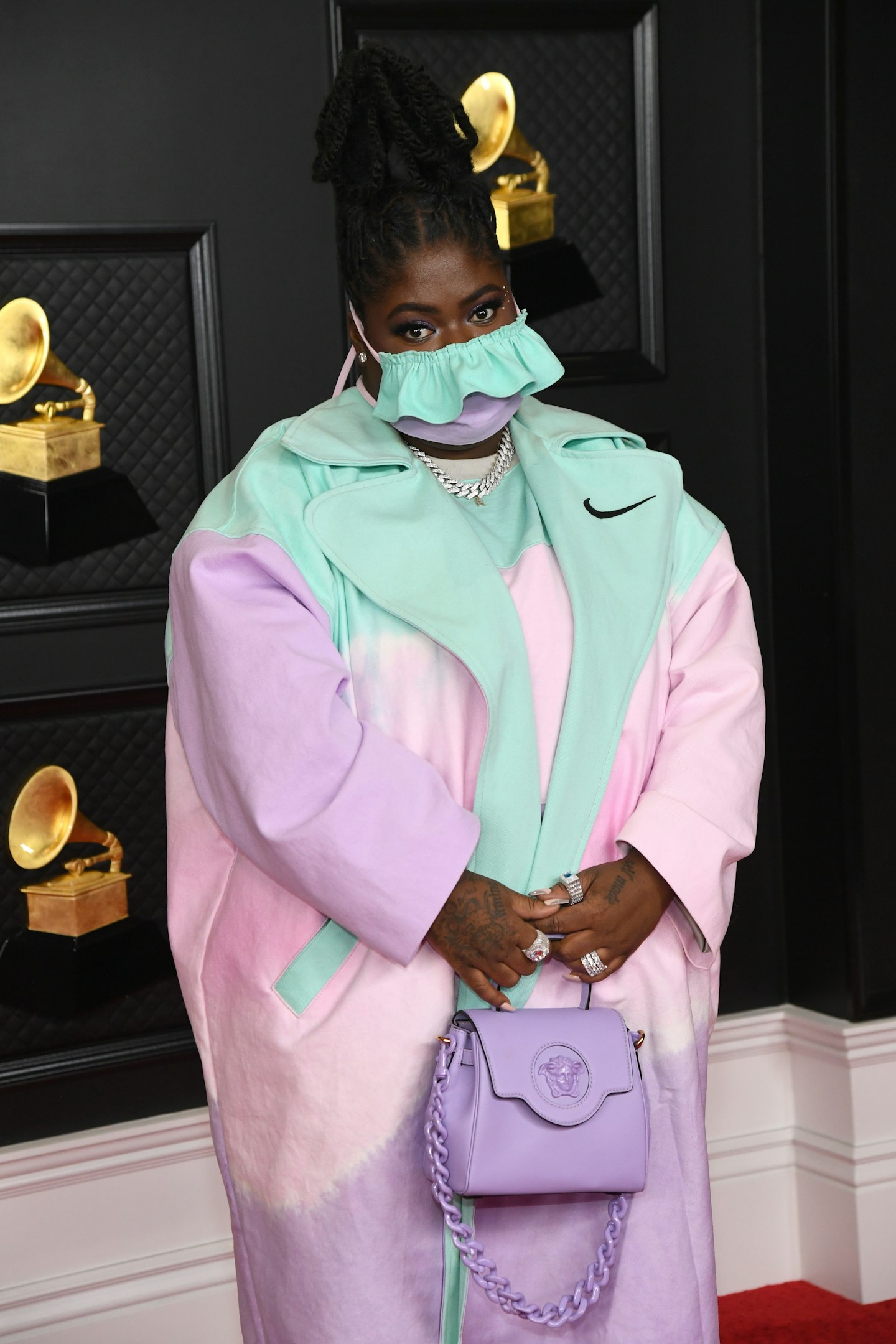 Chika wearing a pastel-coloured face mask and tracksuit at the Grammy Awards 2021