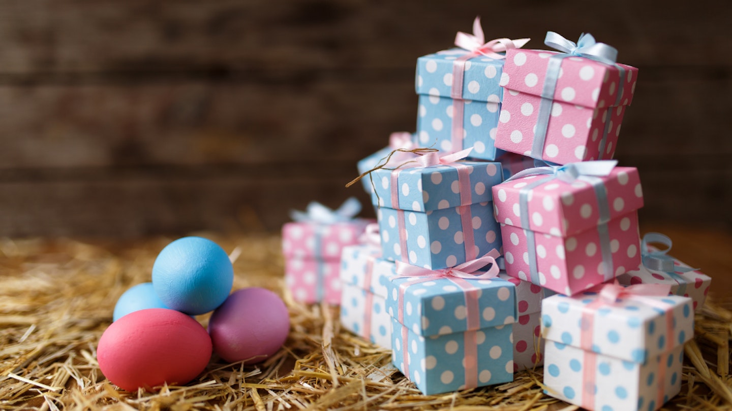 Non-chocolate gifts for Easter picture of presents piled next to some coloured eggs