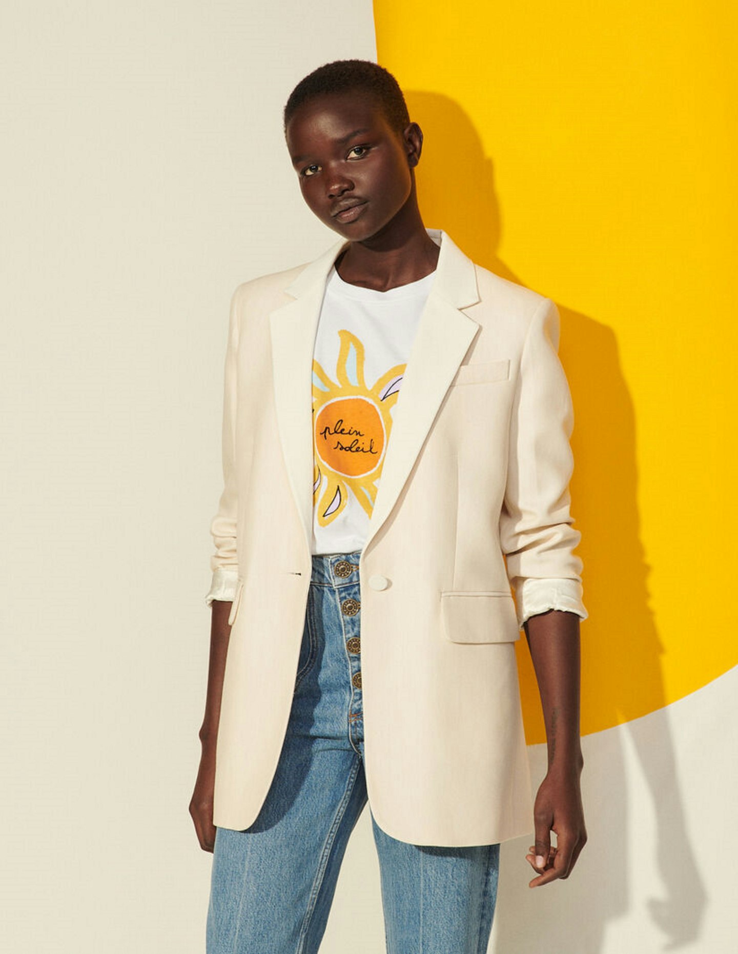A model wearing a pale pink blazer from Sandro 