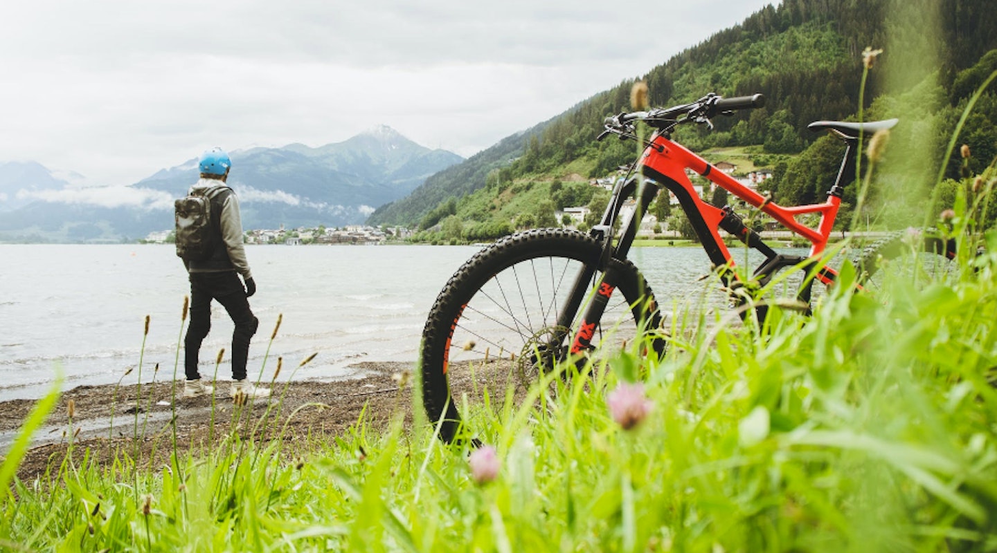Mountain biker taking a rest near lake