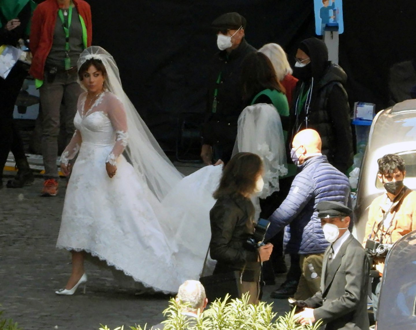 Lady Gaga wearing a wedding dress on the set of The House of Gucci 