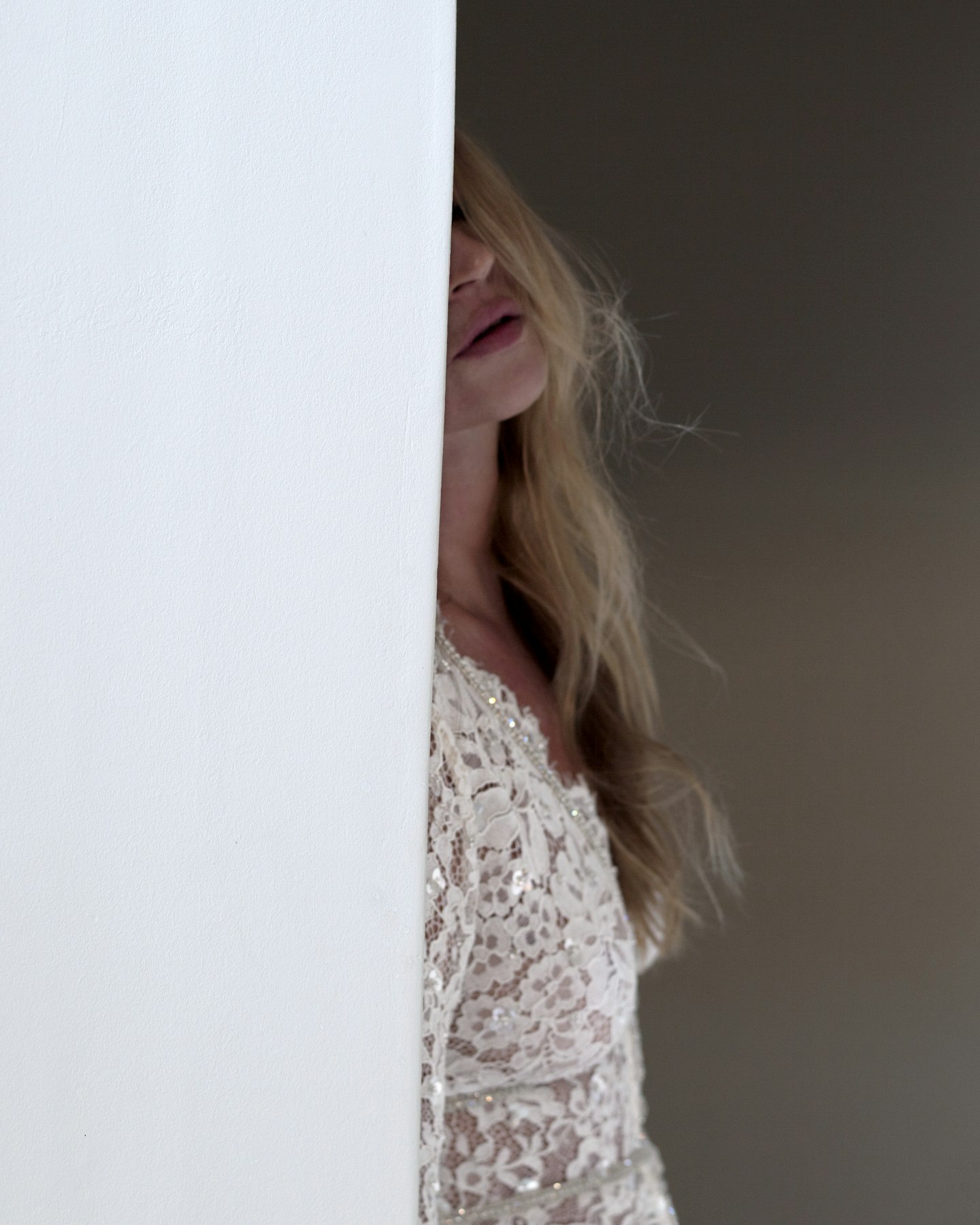 Kate Moss wearing a white lace dress