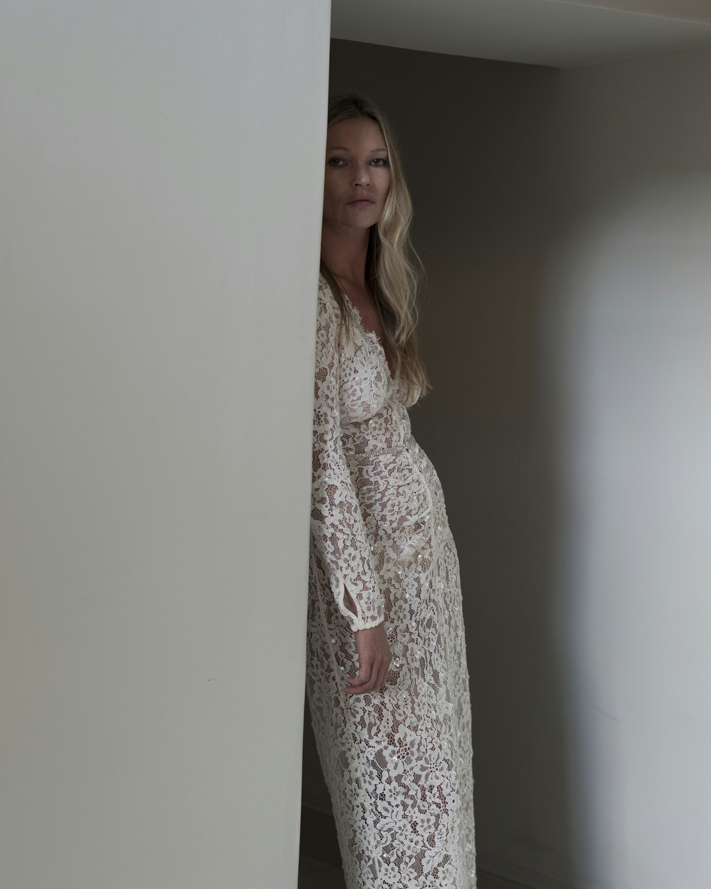 Kate Moss wearing a white lace dress 