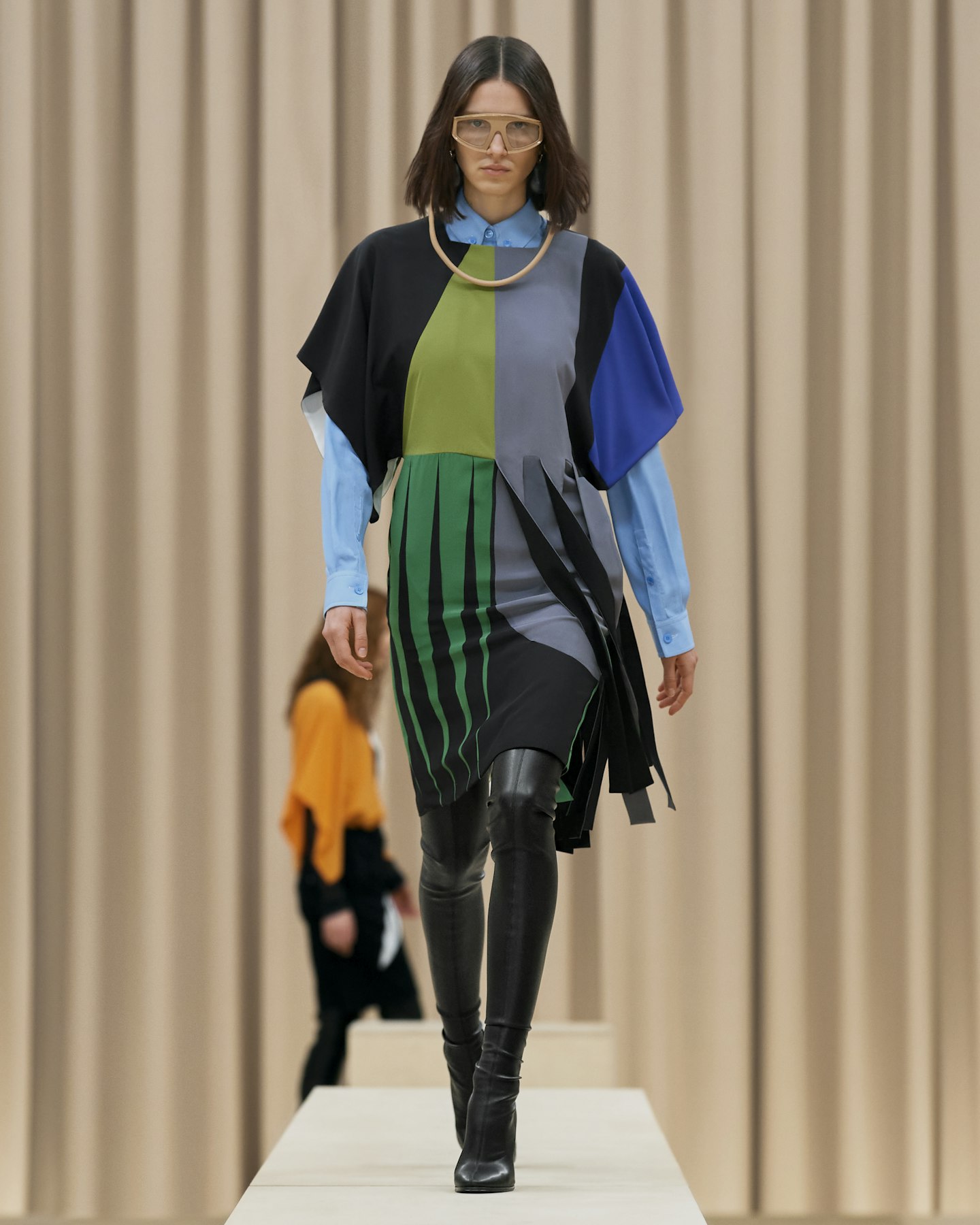 A model wearing a green, grey and blue dress by Burberry AW21