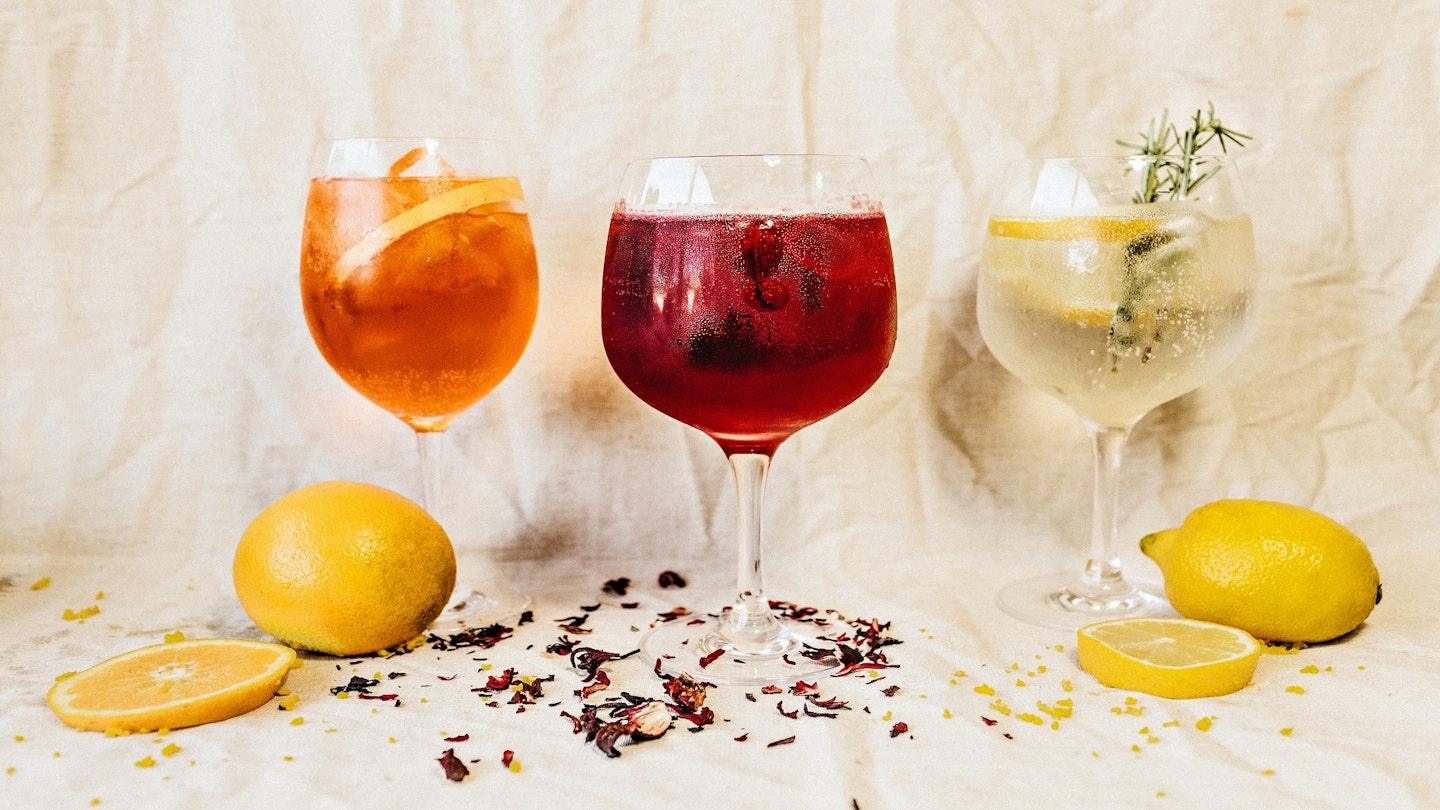 Three different gin cocktails, with two damson gin cocktails on the left and centre.