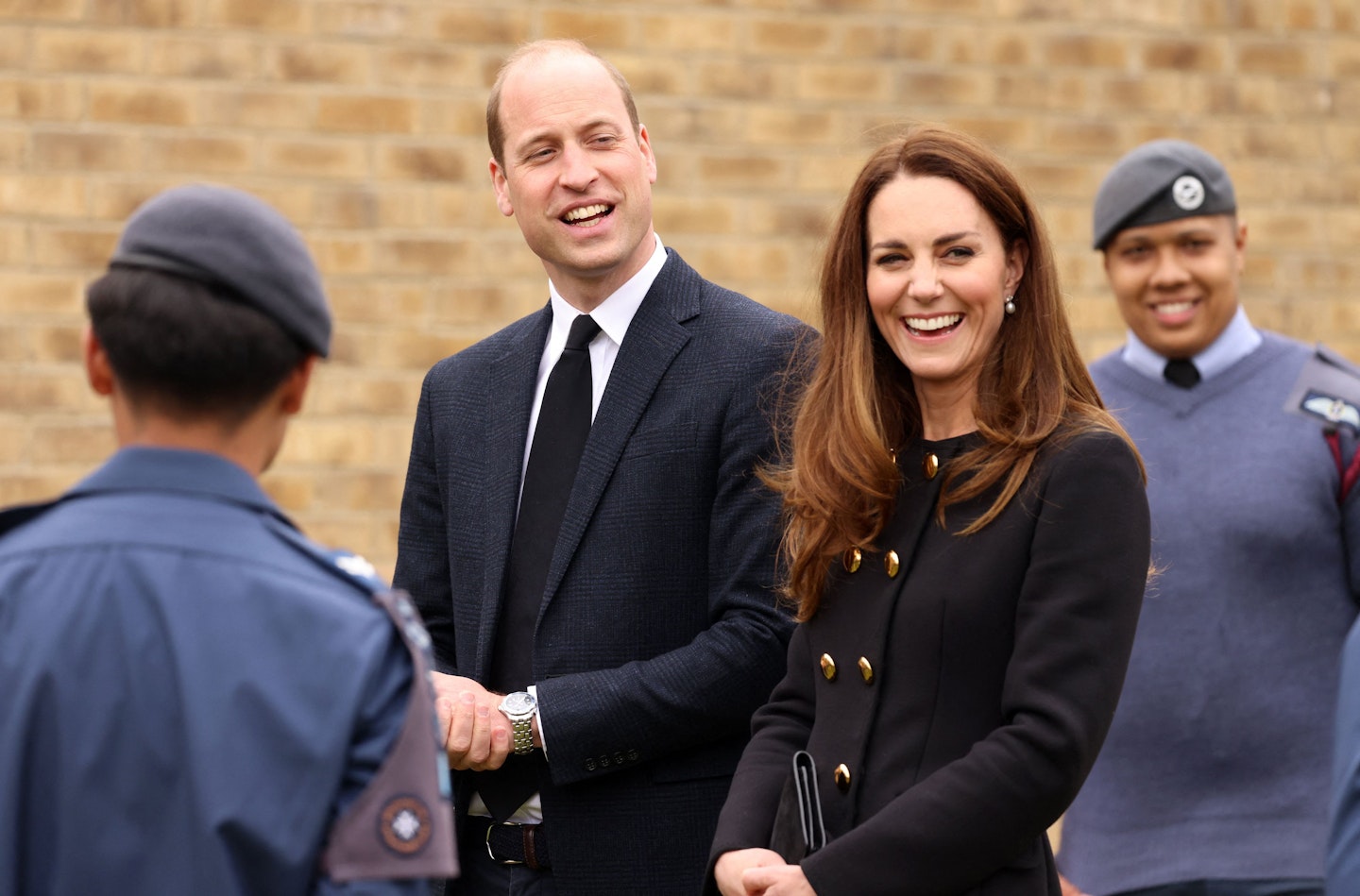 Kate Middleton wearing a black and gold-buttoned coat from D&G
