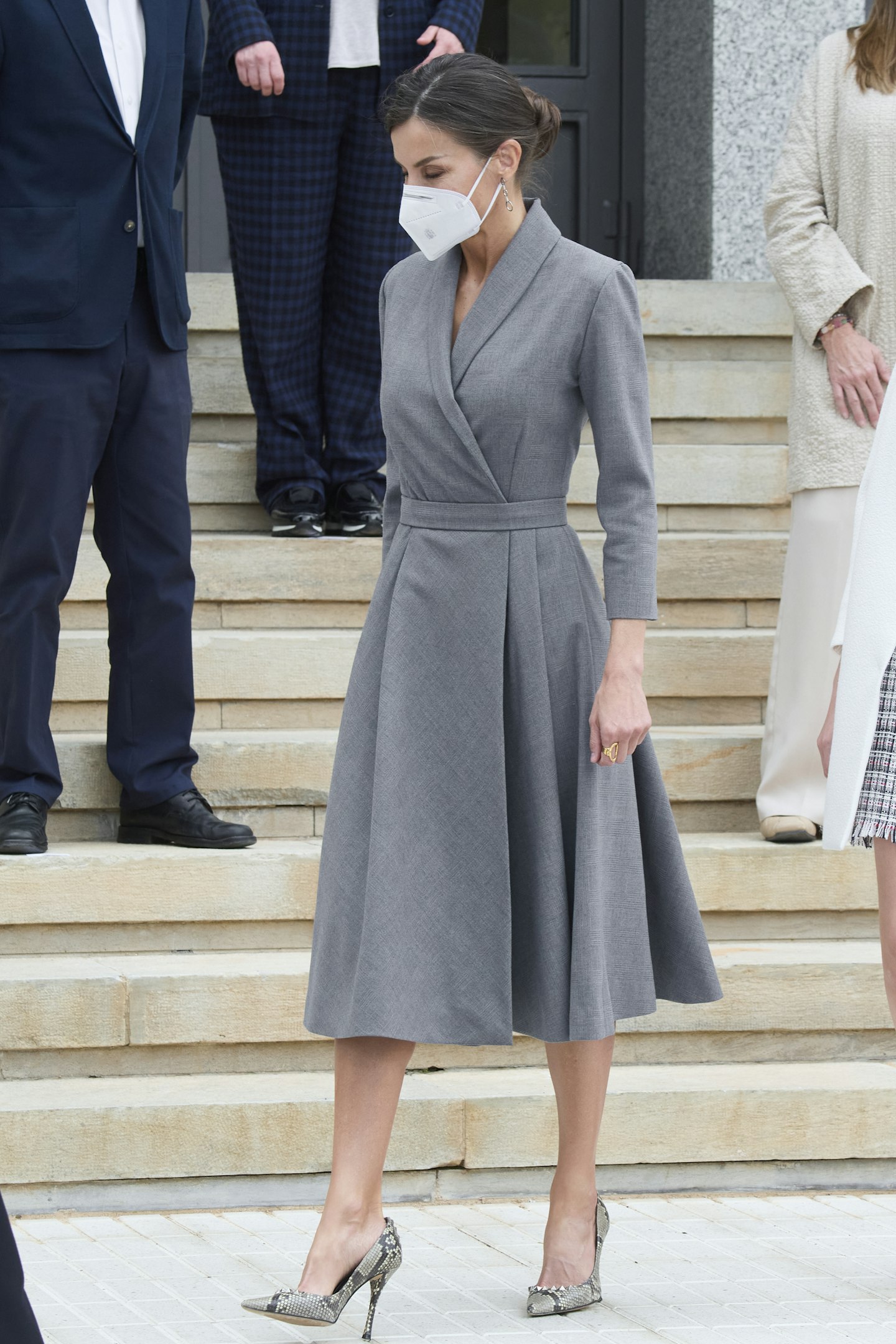 Queen Letizia wearing a grey wrap dress and snake-print heels from Magrit