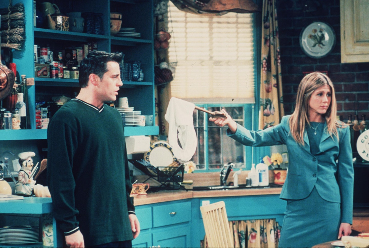 Jennifer Aniston wearing a grey suit as 'Rachel Green' in Friends 