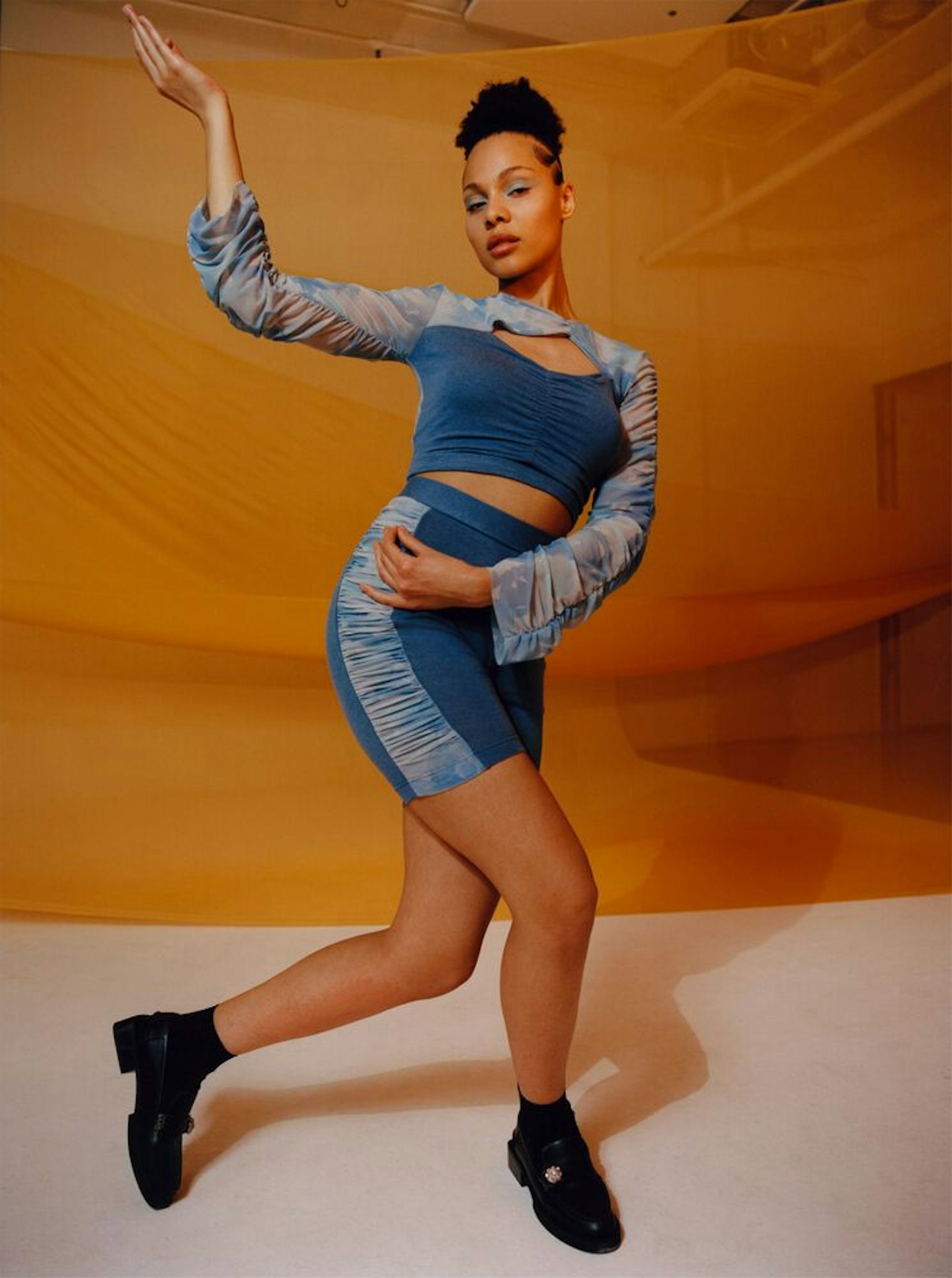 A model wearing a top and skirt from Ganni x Ahluwalia 