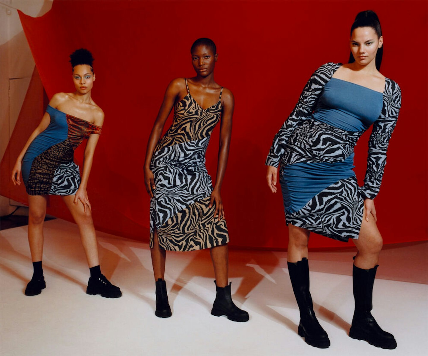 Three models wearing patchwork outfits from Ganni x Ahluwalia