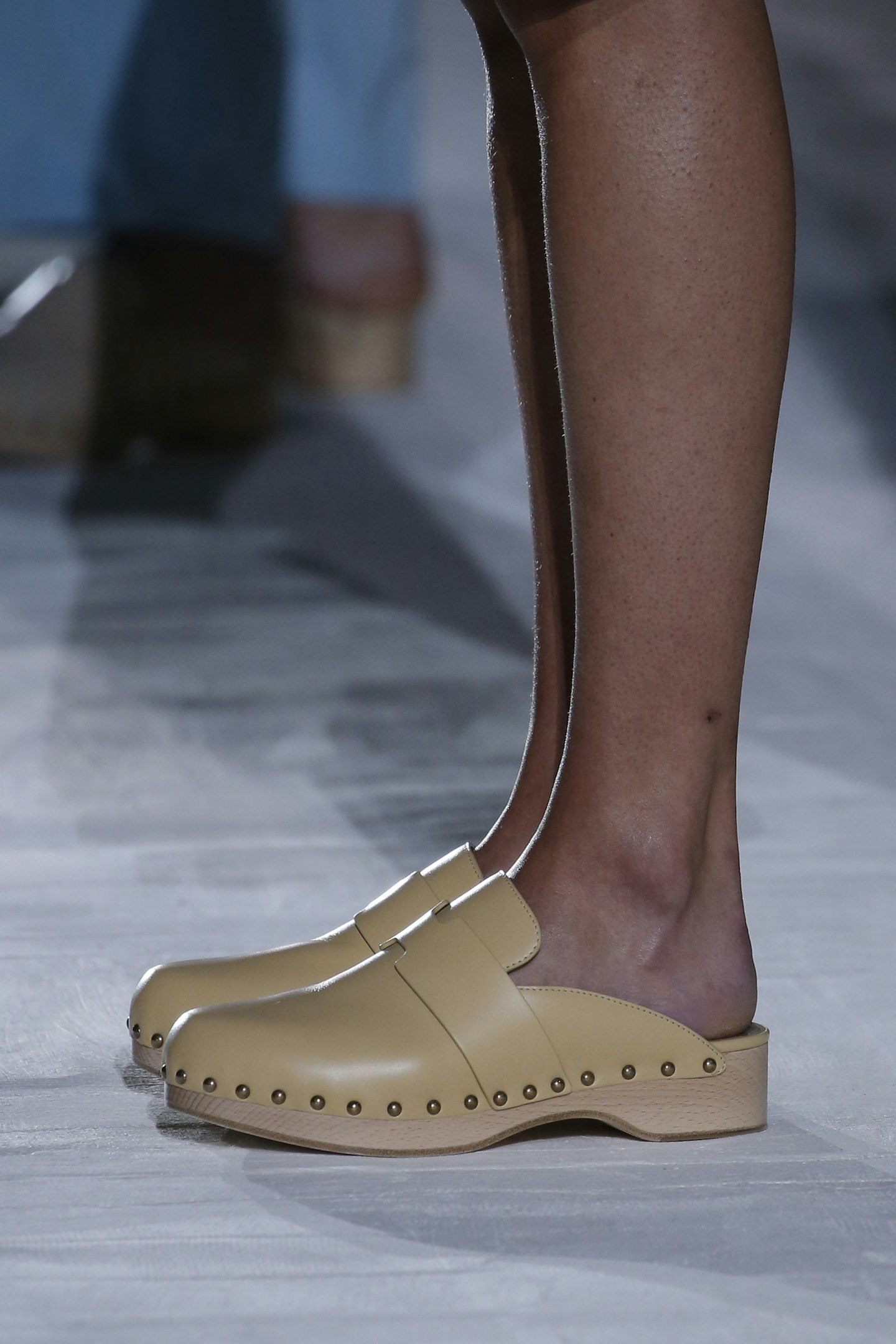 A pair of pale yellow studded clogs from Hermès SS21