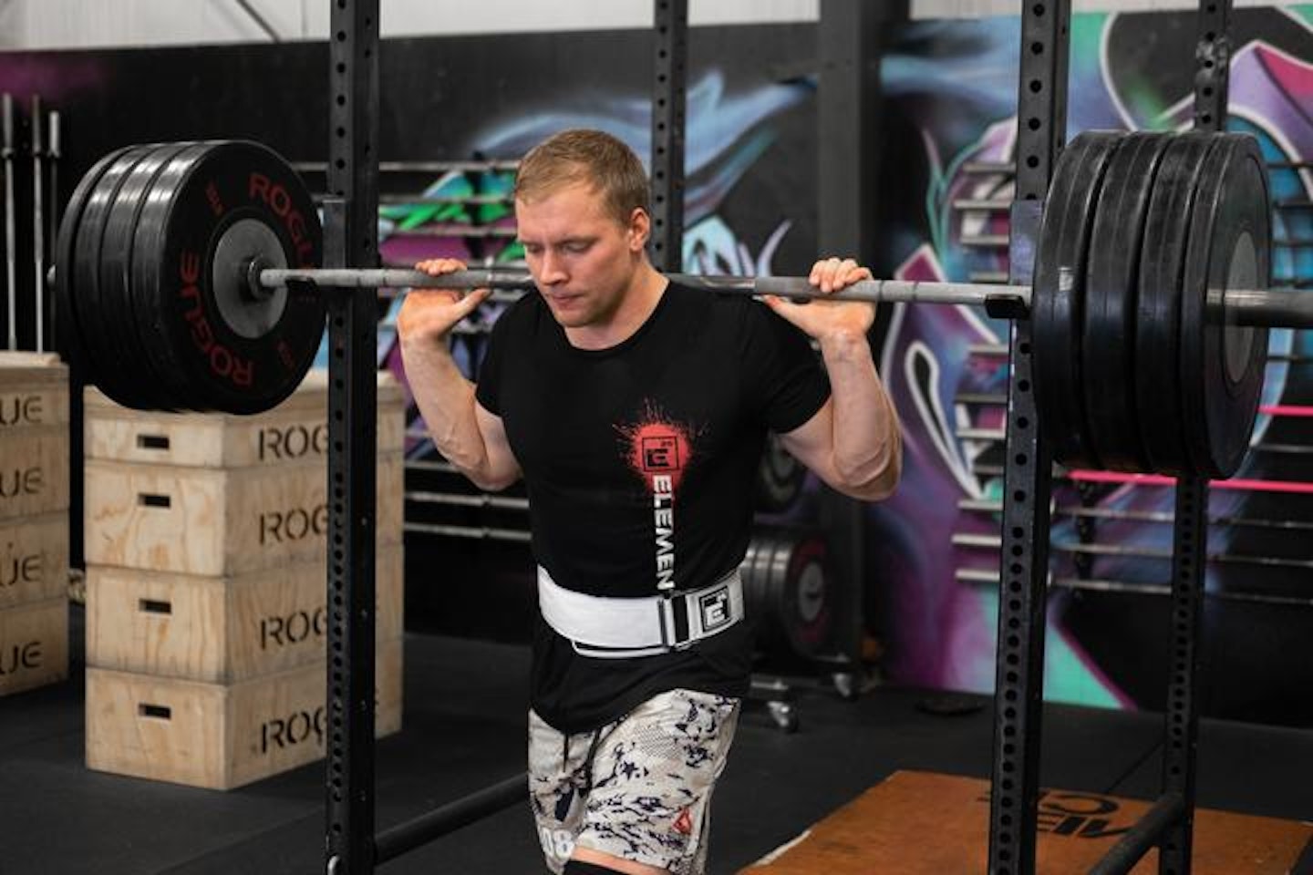 Man lifting barbell wearing Element 26 weight belt