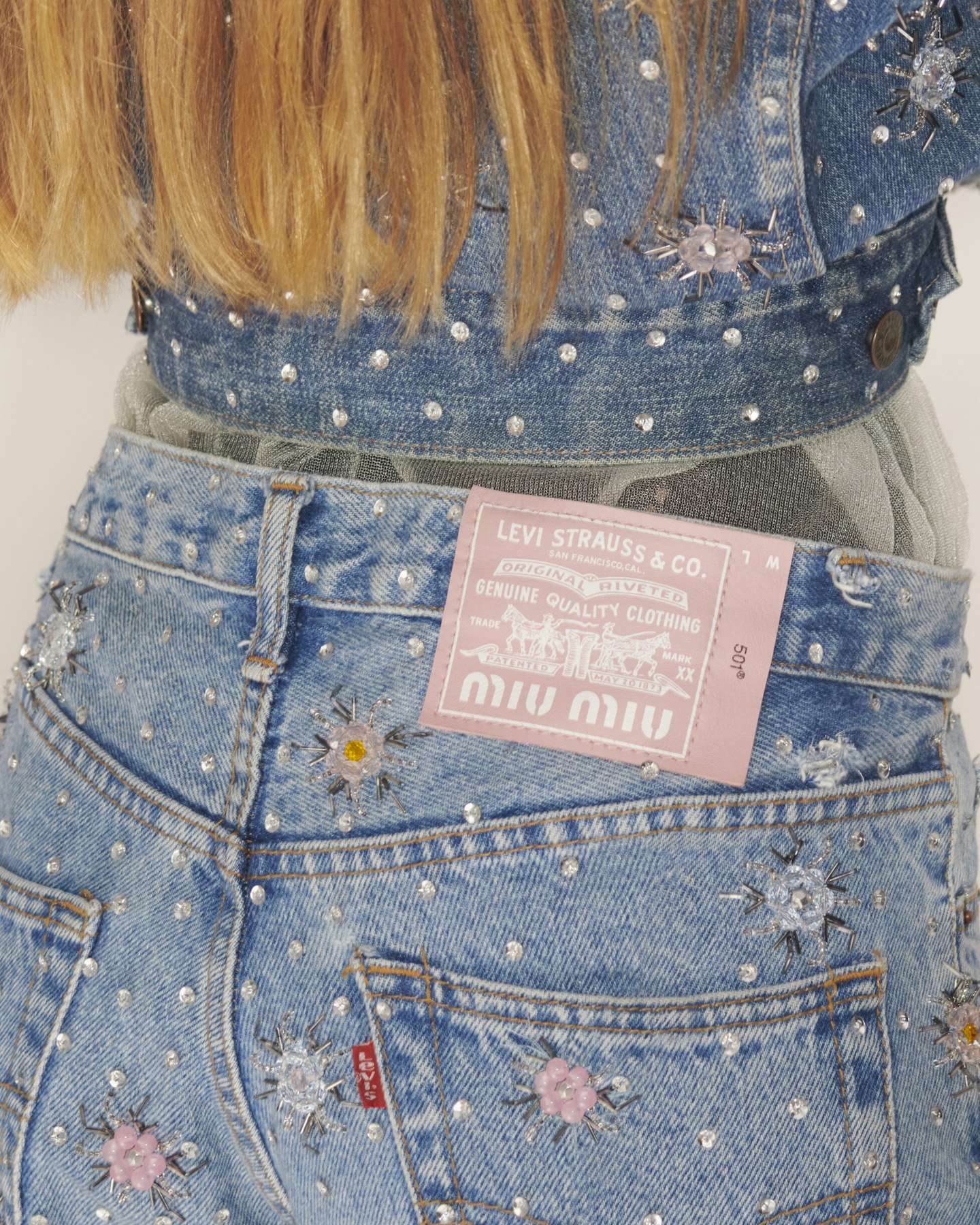 A model wearing jeans from Upcycled by Miu Miu 