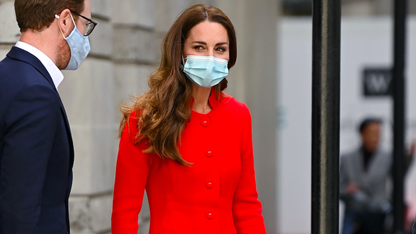 Kate Middleton wearing a red coat and a face mask 