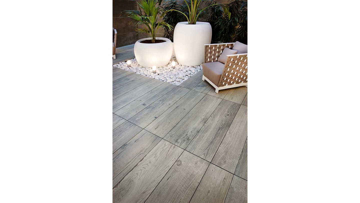 grey plank patio slabs lit up in garden at night
