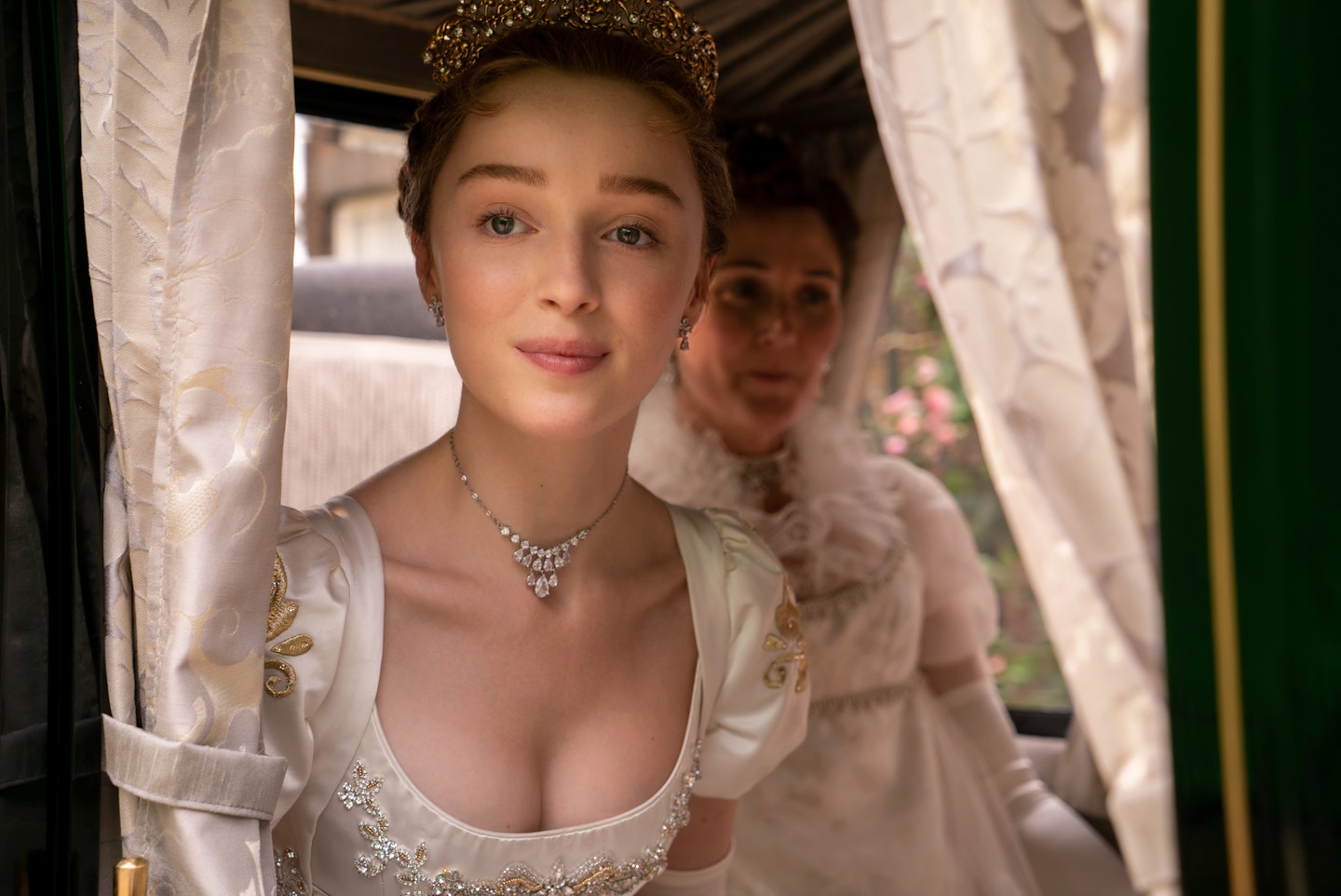 Phoebe Dynevor wearing a white puff-sleeved gown in Bridgerton