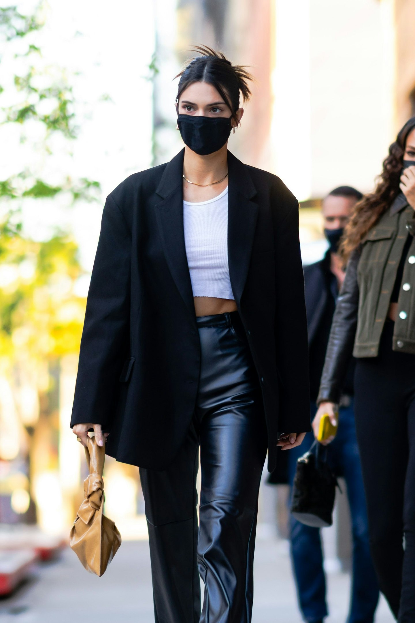 Kendall Jenner wearing a black suit blazer and leather trousers