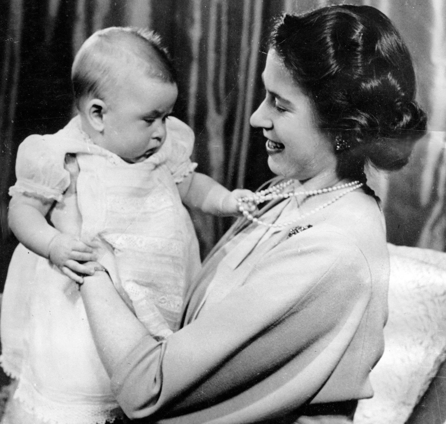 Queen Elizabeth II holding baby Prince Charles