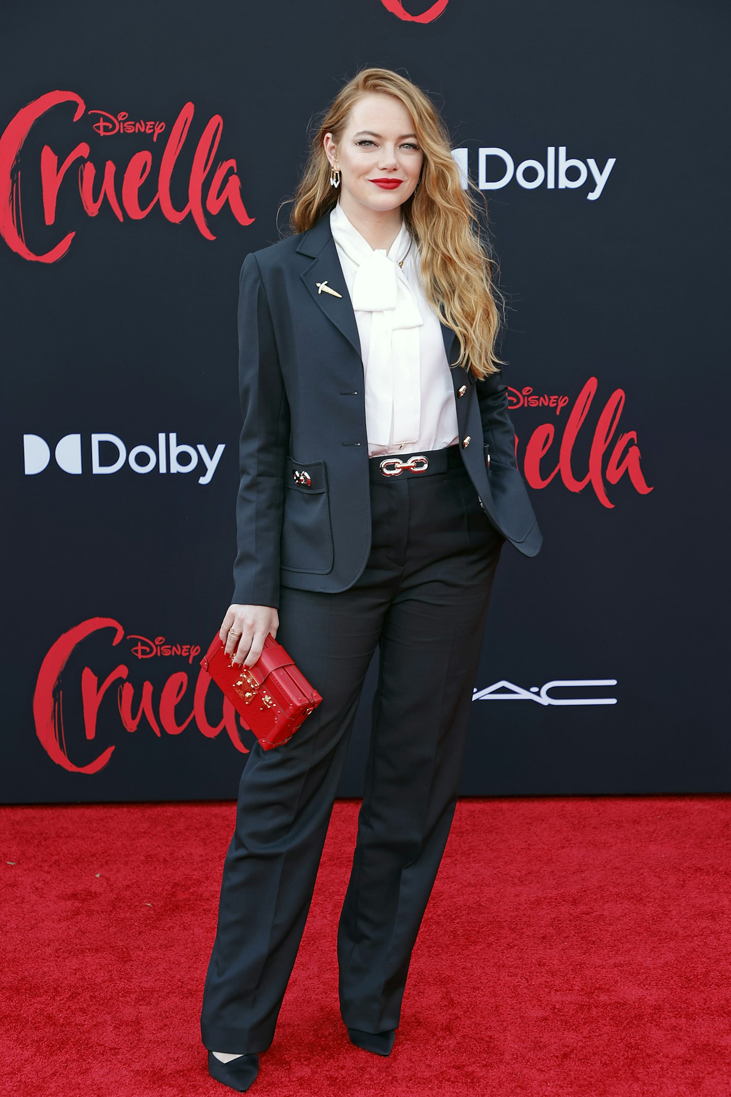 Emma Stone wearing black trouser trouser suit at the premiere of Cruella