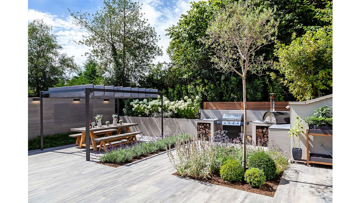 grey wood effect plank pavers in sunny garden with greenery