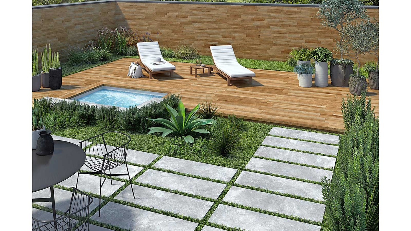 porcelain plank pavers breaking up a lawn in a garden with a deck and sunlounger