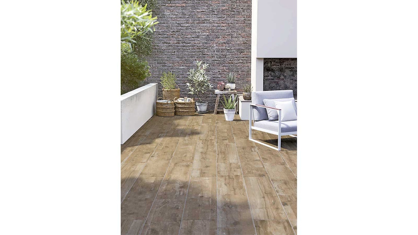 Brown wood effect porcelain plan pavers in a sunny modern garden with white walls