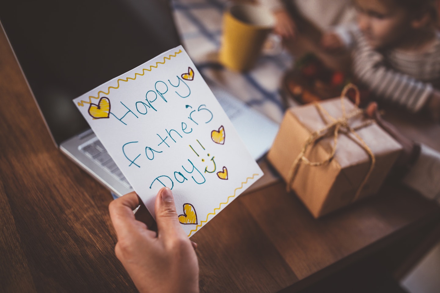 Card with Happy Father's Day in writing alongside gift box
