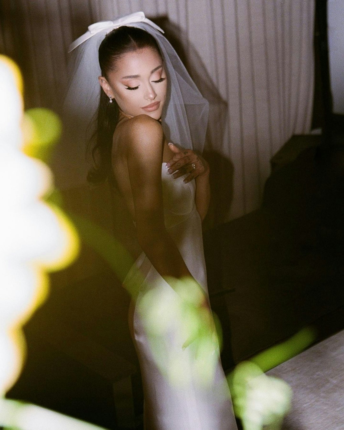 Ariana Grande wearing a strapless wedding dress by Vera Wang