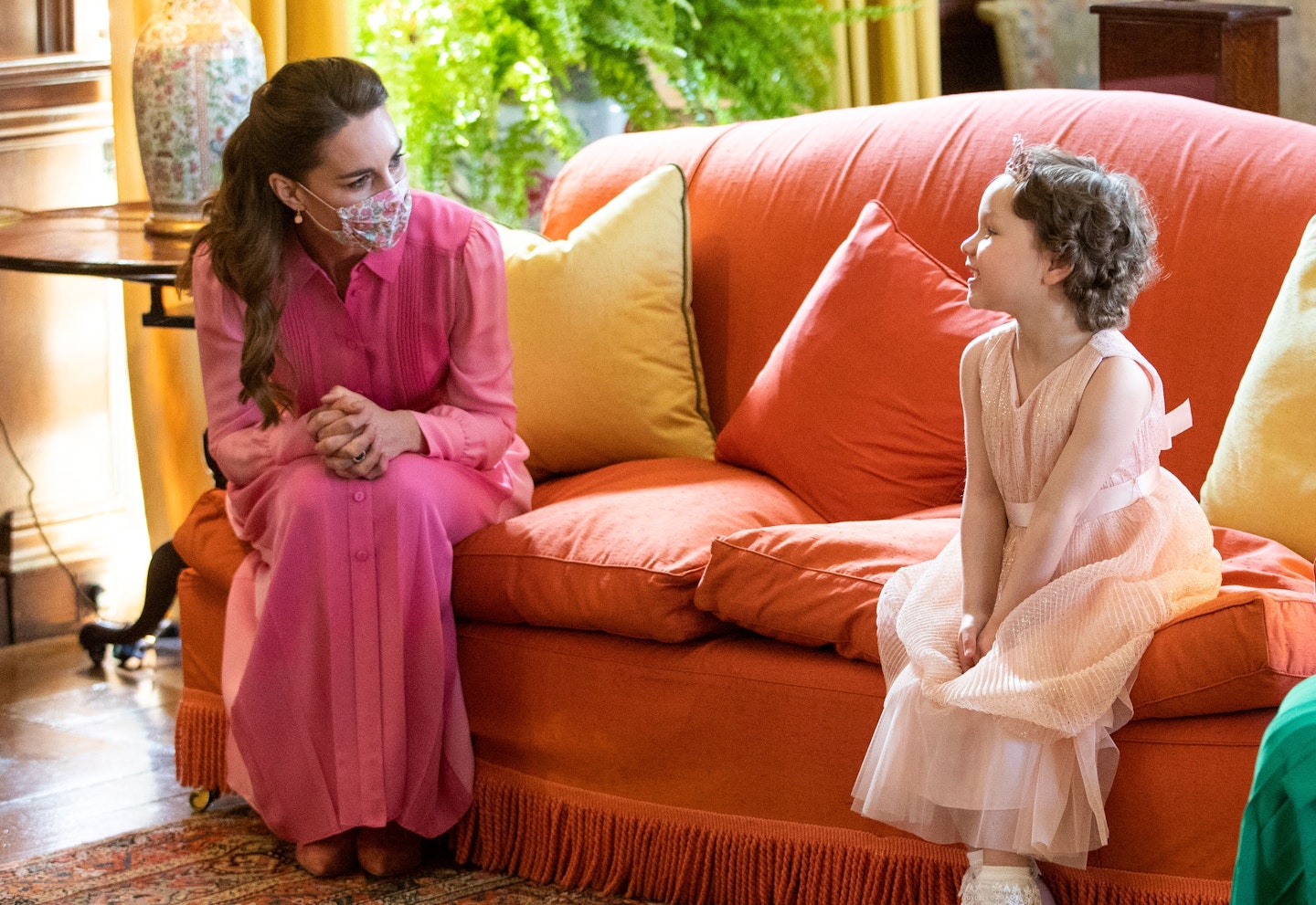 Kate Middleton sitting on a sofa with Mila Sneddon
