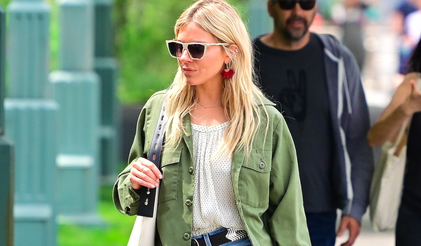 Sienna Miller wearing a khaki jacket and a spotted blouse 