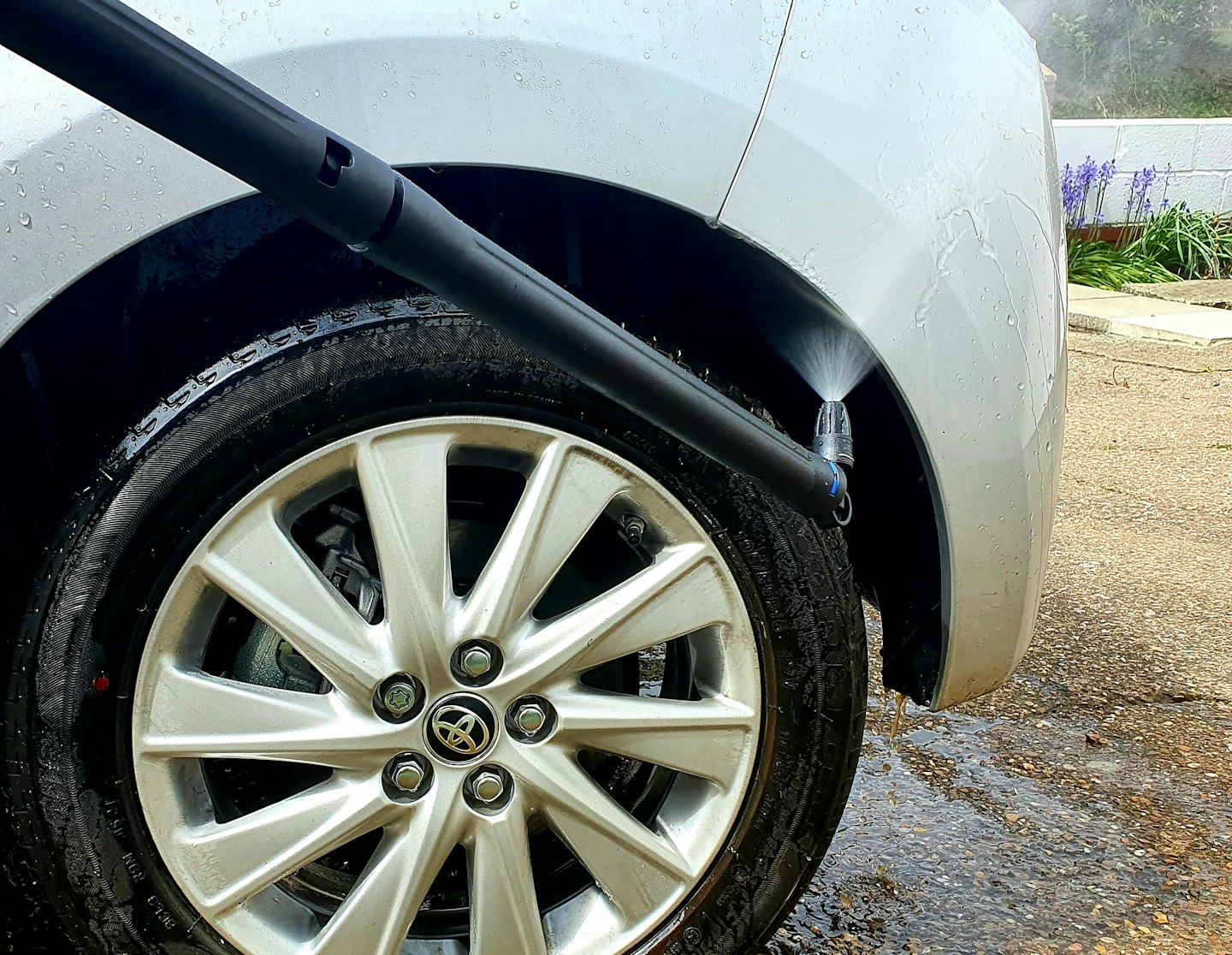Close up of nozzle head in action cleaning wheel