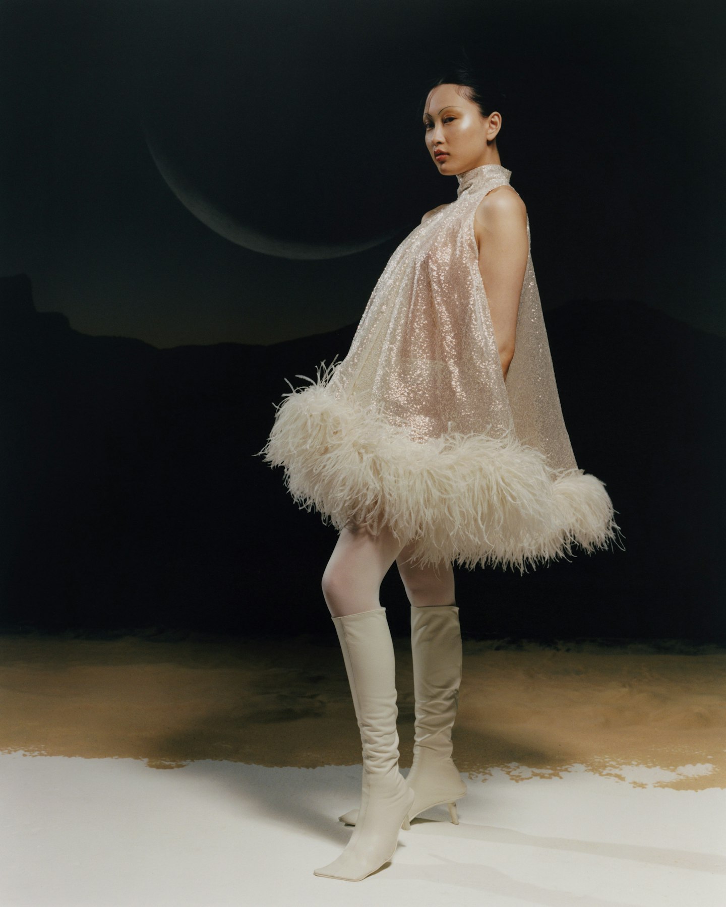 A model wearing a feathered wedding dress from 16 Arlington 