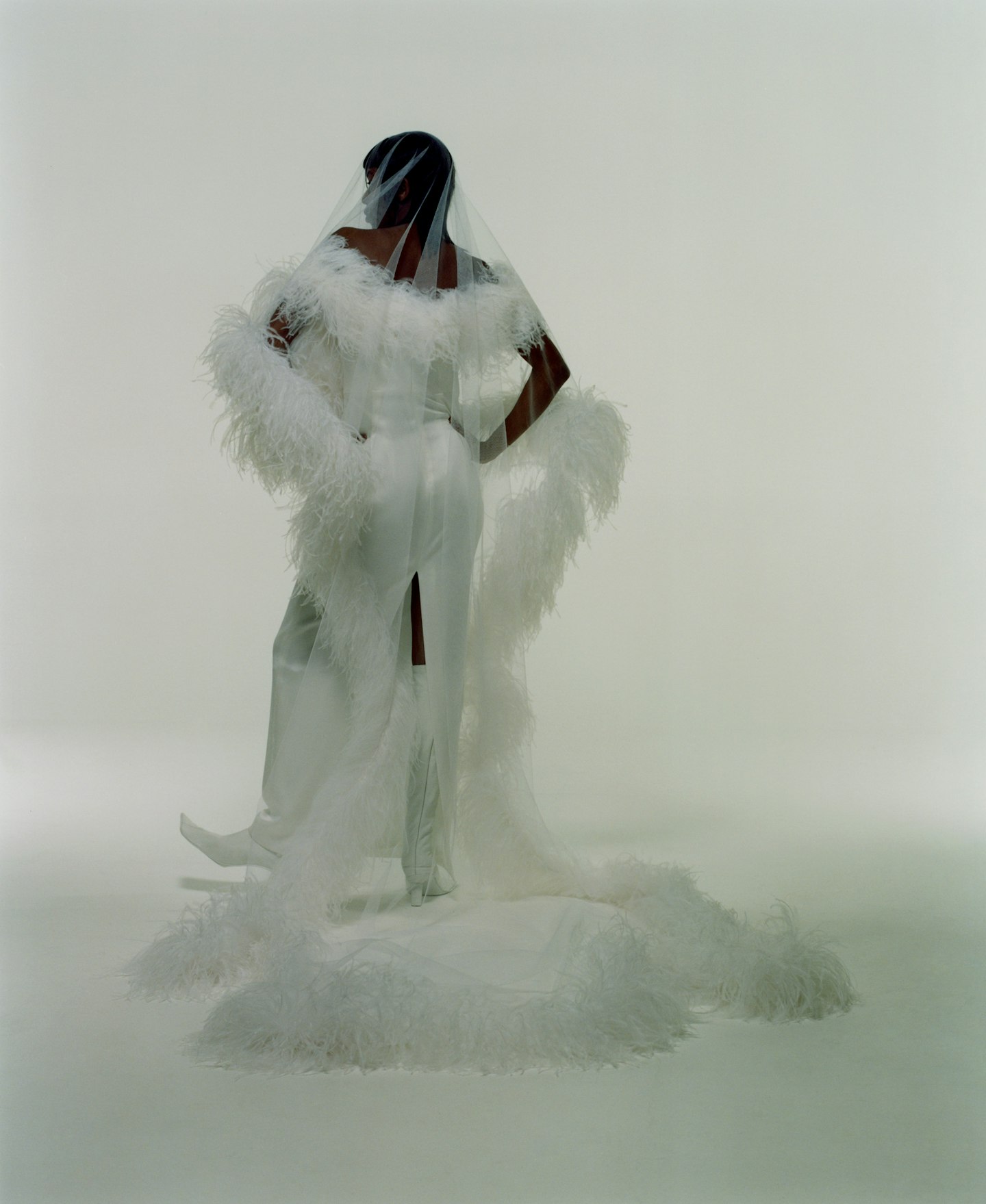 A model wearing a veil and feathered dress from 16 Arlington 