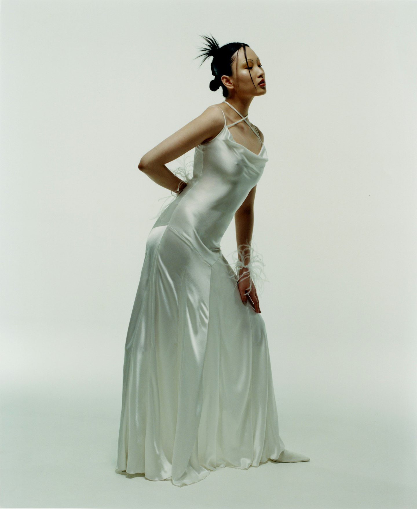 A model wearing a silky wedding dress from 16 Arlington 