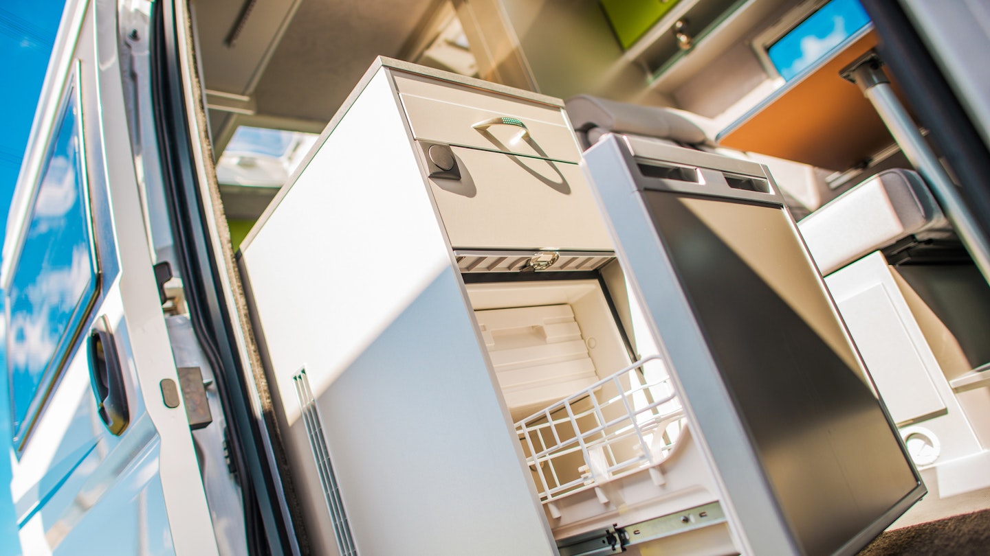 A campervan fridge installed in a campervan